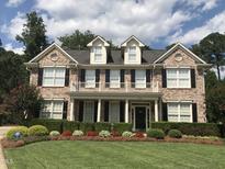 Charming two-story brick home with a manicured lawn and beautiful landscaping at 210 Shillings Chase Dr, Cary, NC 27518