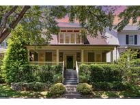 Charming home featuring a welcoming front porch, lush landscaping, and inviting curb appeal at 2205 Karns Pl, Raleigh, NC 27614