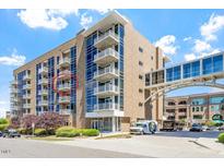 Modern building exterior with private balconies, pedestrian bridge and attractive landscaping at 2410 Environ Way, Chapel Hill, NC 27517