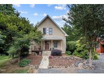 Charming home featuring a stone walkway and a cozy front porch with chairs at 260 Woody Ln, Oxford, NC 27565