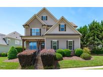Beautiful two-story home featuring a welcoming front porch, landscaped yard, and charming architectural details at 2712 Peachleaf St, Raleigh, NC 27614