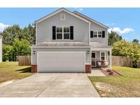 Charming two-story home featuring gray siding, black shutters, and a convenient two-car garage at 3040 Varcroft Rd, Knightdale, NC 27545