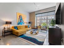 Bright living room features high ceilings, large windows, stylish decor, and a comfortable sectional sofa at 319 Fayetteville St, Raleigh, NC 27601
