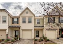 Charming townhome featuring a private garage, complemented by well-maintained landscaping at 3623 Landshire View Ln, Raleigh, NC 27616