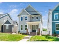Charming two-story home featuring light gray siding and a well-manicured front lawn at 407 Carolina Ave, Raleigh, NC 27606