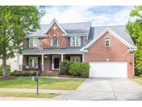Charming two-story brick home with landscaped yard and attached two car garage at 4913 Stockton Way, Durham, NC 27707