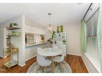 Bright dining area with a round table, modern chairs, and stylish light fixture at 503 Gooseneck Drive # B4, Cary, NC 27513