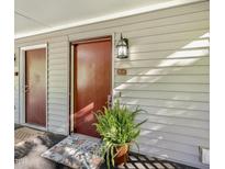 Condo front door with lovely potted plants, an exterior light, and the unit number B-4 at 503 Gooseneck Drive # B4, Cary, NC 27513