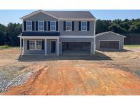 New two-story home with a separate two-car garage and a wide driveway at 59 Sagamore Avenue, Angier, NC 27501