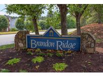 Community sign for Brandon Ridge sits amongst trees and flowering plants at 600 Audubon Lake Dr # 6B13, Durham, NC 27713