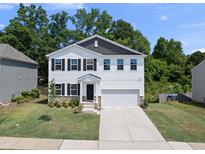 Charming two-story home with white siding, black shutters, and a well-manicured lawn at 77 Rolling Creek Cir, Clayton, NC 27520