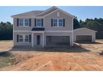 Charming two-story home with attached and detached garages on a spacious lot at 83 Sagamore Avenue, Angier, NC 27501