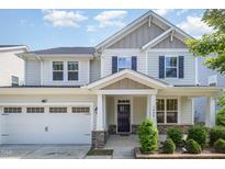 Charming two-story home featuring a well-manicured lawn, inviting front porch, and a convenient attached two-car garage at 1009 Travern Dr, Raleigh, NC 27603
