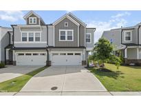 Charming townhome with a two-car garage and well-manicured front yard at 1011 Canary Pepper Dr, Durham, NC 27713