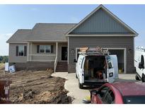 Charming single-story home with a covered front porch and attached two-car garage at 112 Royal Ave, Selma, NC 27576
