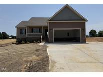 Charming single-story home featuring a two-car garage and covered front porch, all nestled on a spacious lot at 112 Royal Ave, Selma, NC 27576