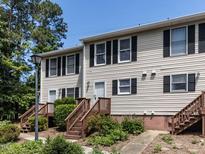 Charming townhome featuring neutral siding, black shutters, and inviting entry stairs at 113 Weatherstone Dr # B, Chapel Hill, NC 27514