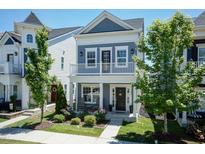 Charming two-story home with a balcony, landscaped yard, and inviting curb appeal at 1223 Brown Velvet Ln, Apex, NC 27523