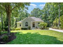 Inviting single-story home with well-maintained landscaping and a charming facade at 12733 Pamplona Dr, Wake Forest, NC 27587