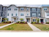 Charming townhouse with colorful exteriors, manicured lawn, and inviting walkways at 1314 Rosepine Dr, Cary, NC 27519
