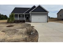 Charming single-Gathering home with a two-car garage and a well-manicured lawn in a residential area at 134 Royal Ave, Selma, NC 27576
