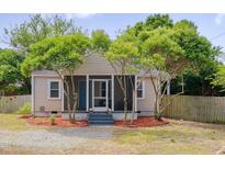 Charming home featuring beautiful trees and landscaping, offering great curb appeal at 1429 Hudson Ave, Durham, NC 27705