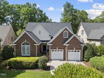 Charming brick home with a two-car garage and well-manicured landscaping in a suburban setting at 156 Yorkchester Way, Raleigh, NC 27615