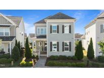 Charming two-story home featuring gray siding, dark shutters, and a landscaped front yard at 1641 Silo Ridge Dr, Wake Forest, NC 27587