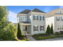 Charming two-story home with beautiful landscaping and a welcoming front porch at 1641 Silo Ridge Dr, Wake Forest, NC 27587
