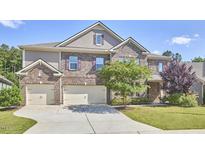 Charming brick home with a well-manicured lawn and a three-car garage at 1808 Capstone Dr, Durham, NC 27713