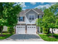 Charming two-story home featuring a two-car garage and manicured front lawn at 1908 Woodsdale Dr, Durham, NC 27703