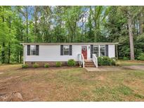Charming single-story home featuring white siding, black shutters, and a welcoming red front door at 196 Marlin Ln, Smithfield, NC 27577