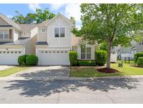 Charming two-story home with a well-manicured lawn and attached two-car garage at 207 Bell Tower Way, Morrisville, NC 27560