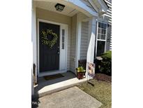 Charming front door with wreath, welcome mat, and inviting decor at 207 Bell Tower Way, Morrisville, NC 27560