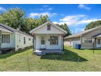 Charming single story home featuring a cozy porch and well-maintained lawn at 215 N 4Th St, Smithfield, NC 27577