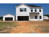 New two-story home with white siding, black shutters, a two-car garage, and a detached single-car garage at 22 Sagamore Avenue, Angier, NC 27501
