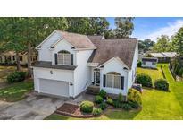 Charming two-story home featuring a manicured lawn, attached garage, and inviting curb appeal at 2240 Delaney Dr, Burlington, NC 27215
