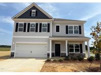 Charming two-story home featuring a light gray exterior, complemented by a two-car garage and classic black accents at 241 E Victory View Ter, Smithfield, NC 27577