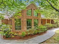 Charming brick home featuring large windows and professional landscaping at 2600 Snow Hill Rd, Durham, NC 27712