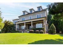 Inviting exterior of home with manicured lawn and stone accents at 3209 Bryant Falls Ct, Raleigh, NC 27613