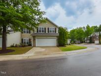 Charming two-story home features a well-manicured lawn and an attached two-car garage at 3339 Archdale Dr, Raleigh, NC 27614