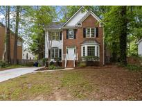 Charming two-story home with a well-manicured front yard, brick facade, and welcoming entrance at 3401 Scotch Dr, Raleigh, NC 27616