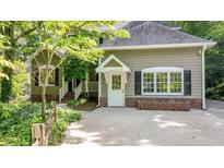 Charming home featuring a welcoming entrance with a white front door and manicured landscaping at 4713 Little Falls Dr, Raleigh, NC 27609