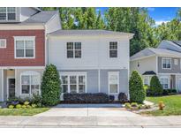 Charming townhouse with landscaped front yard and manicured bushes, featuring a neutral color scheme and inviting curb appeal at 534 Elm Ave, Wake Forest, NC 27587