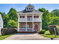 Charming two-story home boasts dual porches, stone accents, and mature landscaping at 5865 Forest Point Rd Rd, Raleigh, NC 27610
