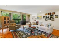 Bright living room featuring a white sofa, cozy chair, and balcony with scenic outdoor views at 620 Martin Luther King Jr Blvd # Apt 502, Chapel Hill, NC 27514