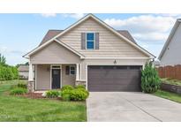 Charming home with a two-car garage, well-maintained lawn, and attractive landscaping at 904 Palm Ct, Mebane, NC 27302