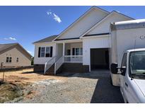 New construction home features a welcoming front porch and an attached two-car garage at 94 Royal Ave, Selma, NC 27576