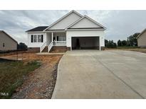 Charming single Gathering home with inviting front porch and an attached two car garage at 94 Royal Ave, Selma, NC 27576