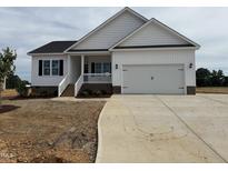 Charming single-Gathering home featuring a two-car garage, welcoming front porch, and modern farmhouse design at 94 Royal Ave, Selma, NC 27576